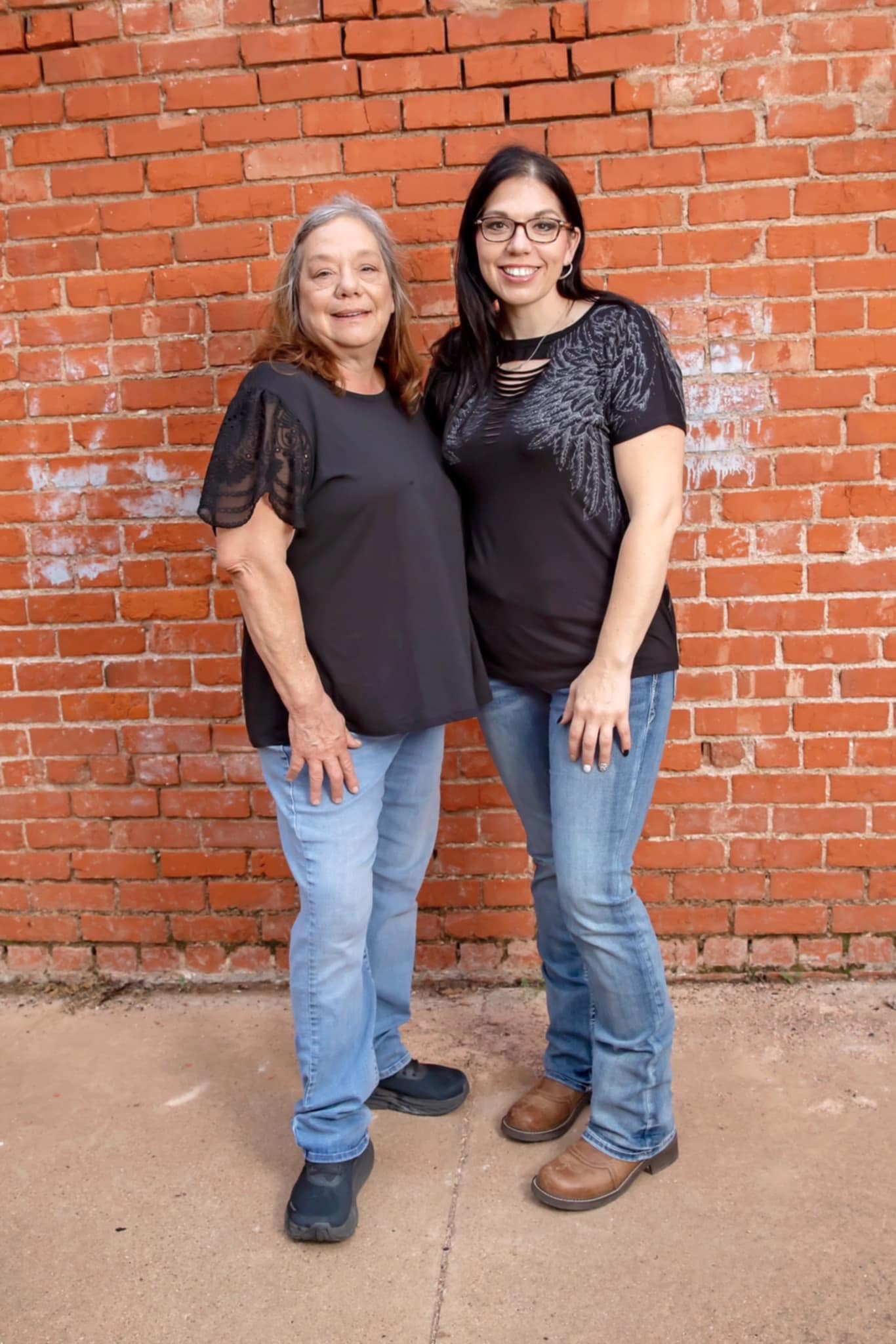 Crystal Roberts and team standing together by a brick wall